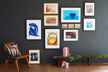 A selection of Tate custom prints hanging on a grey wall