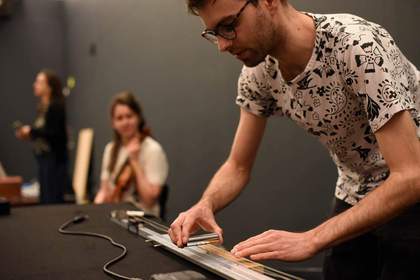 Person using a solid steel guitar slide